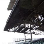 Debris mesh netting installed under seating in a sports stadium