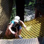 A child climbing a net ramp