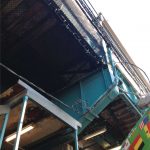 Safety netting installed on the underside of a commuter rail platform.