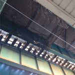 Safety netting attached with cabled under an elevated commuter rail station.