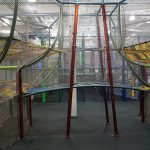 A rope bridge connecting two play areas in a structure.