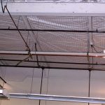 Netting used to control ceiling debris from falling on pedestrians.