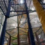 Levels of climbing nets leading to the top of a play structure.
