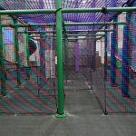 The entrance to a maze constructed out of mesh netting.