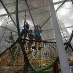 Children playing on a climbing net.