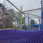 A rope bridge with barrier mesh netting.