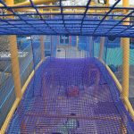 A rope bridge with barrier netting
