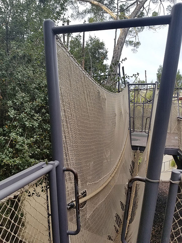 A damaged climbing net at a children's museum.