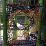 A multi-colored tunnel made of netting