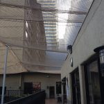 Netting protects a commercial arcade from falling debris.