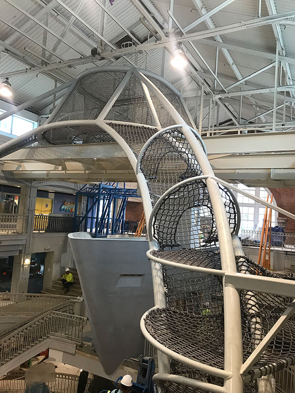 The form of a boat takes shape under The SkyClimber at Port Discovery.