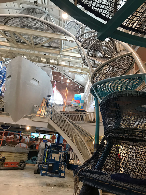 The Sky Climber arches above the boat at Port Discovery Children's Museum.