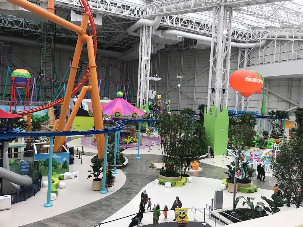 An indoor amusement park featuring roller coasters