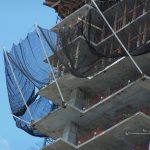 Safety netting outrigger arms on a construction project.