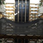 Netting in a hotel lobby provides protection from falling debris