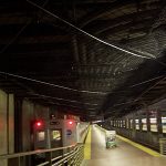 Netting affixed the ceiling of a busy commuter train station, protects pedestrians from falling debris.