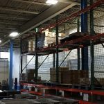 Storage rack safety netting installed in a warehouse.