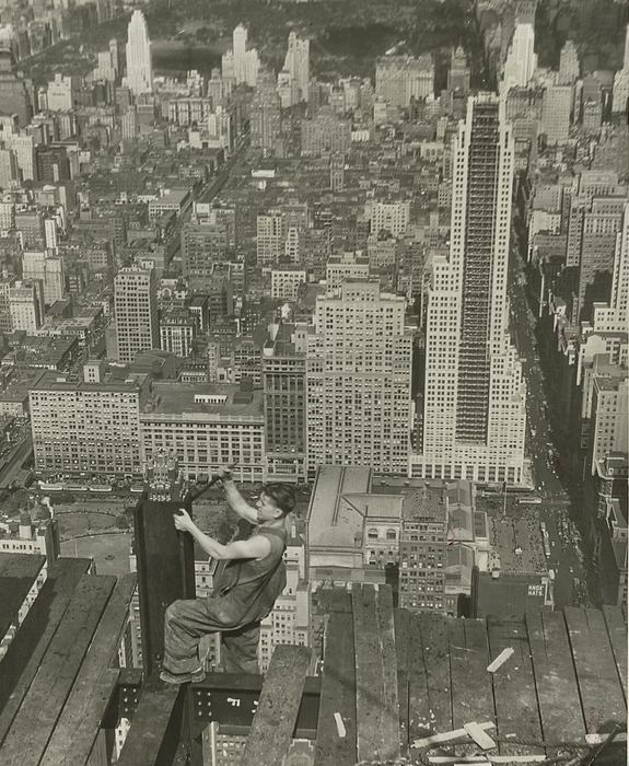 A worker tightens a bolt on a column during the construction of the Empire State Building.
