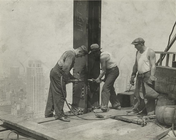 Steel workers putting rivets into a steel column on the Empire State Building.