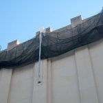 Wall mounted safety netting in a retracted position.