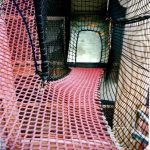 Climbing nets can lead in many directions, allowing people to move from one level to another in tight spaces.