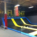 Barrier netting at a trampoline park keeps activities separate.