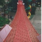 A red rope net bridge.