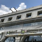 A facade containment system being installed on a building until permanet repairs can be carried out.